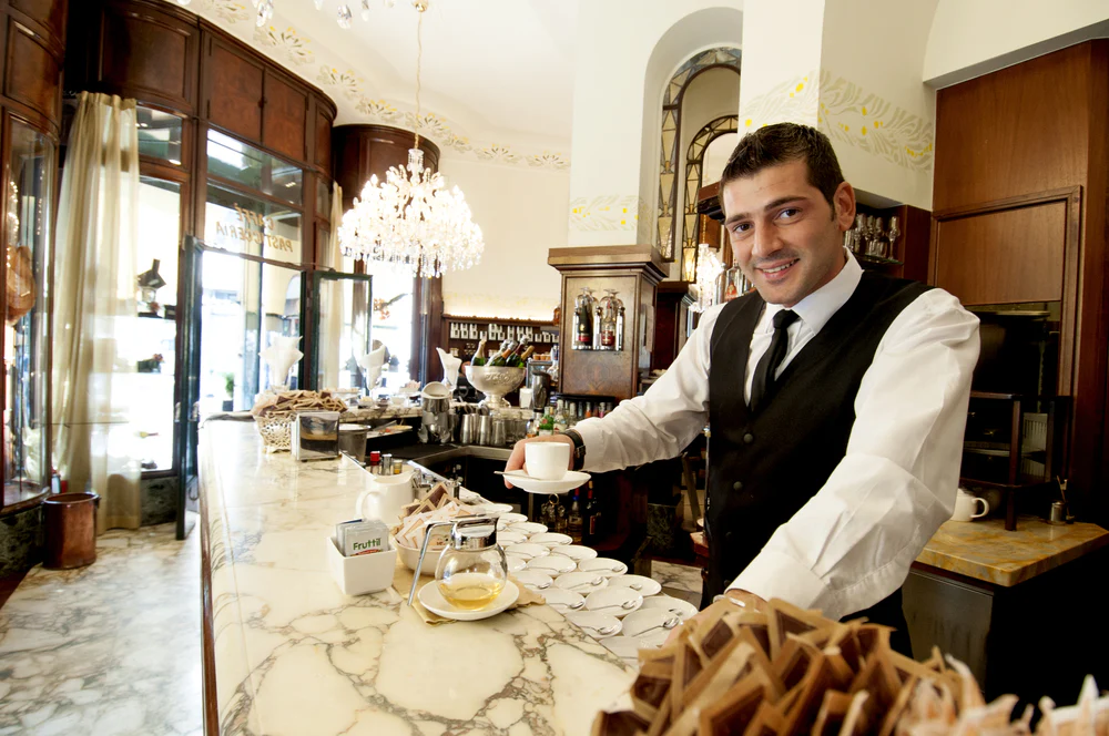 Barista serving espresso